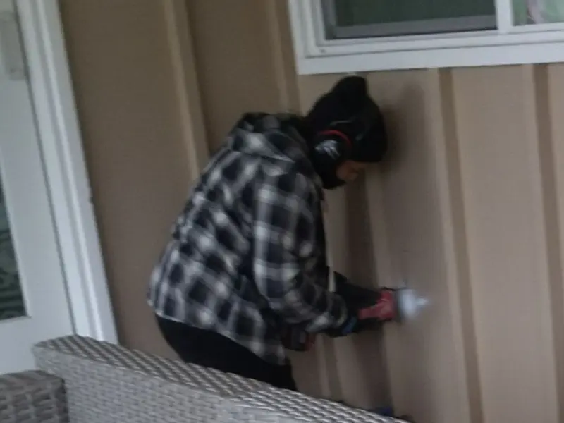 Professional electrician installing an exterior outlet in Candor